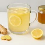Warm natural detox drink with lemon, ginger, and honey on rustic table