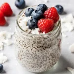 Coconut Chia Seed Pudding: The Ultimate Healthy Dessert Recipe That Actually Works 1 Creamy coconut chia seed pudding in glass jar with fresh berries and coconut flakes