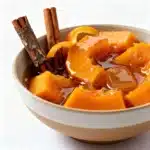 A modern white bowl filled with authentic Calabaza en Tacha,