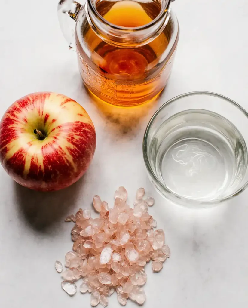 pink salt acv drink ingredients close up Ingredients for making pink salt and apple cider vinegar drink including raw ACV and Himalayan salt