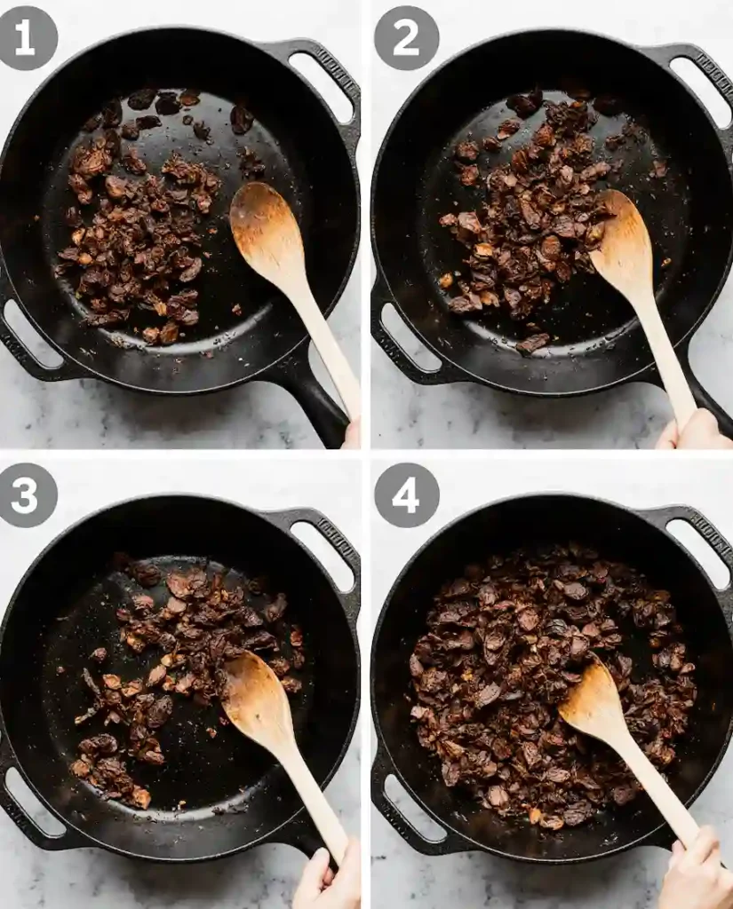 toasting-chiles-birria-ramen Dried guajillo and ancho chiles being toasted in a skillet for a birria ramen recipe.