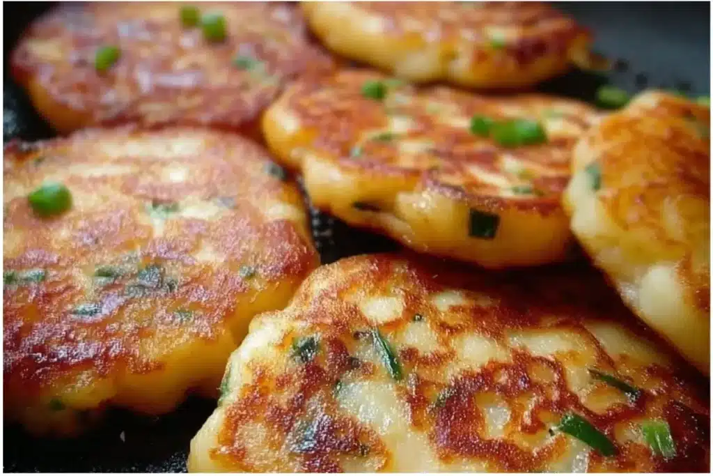 Delicious Gamjajeon pancakes served with dipping sauce on a plate.