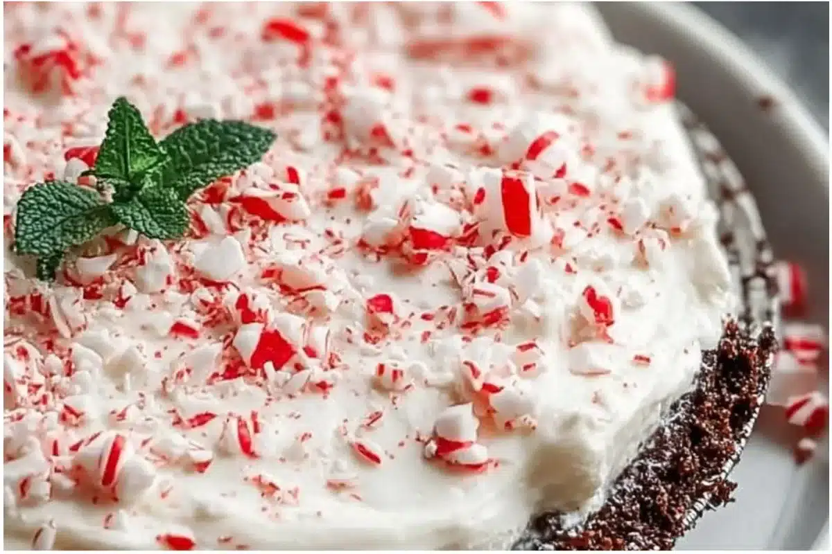 Quick Christmas Peppermint Pie topped with whipped cream and peppermint sticks
