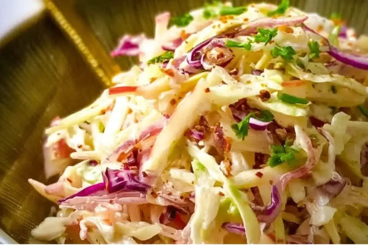 Bowl of sweet and tangy apple coleslaw salad with fresh ingredients