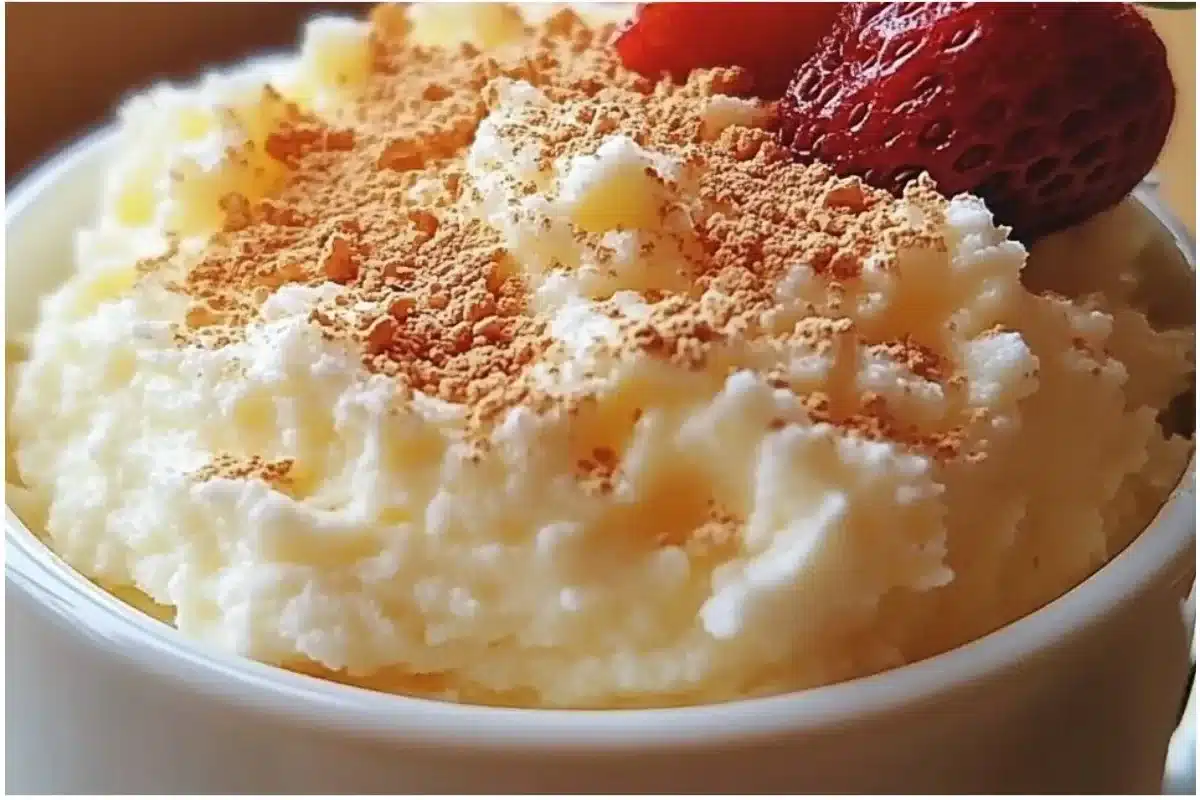 Delicious cottage cheese mug cake served in a white mug on a wooden table.