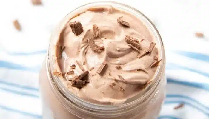 Delicious whipped hot chocolate topped with fluffy whipped cream in a cozy mug