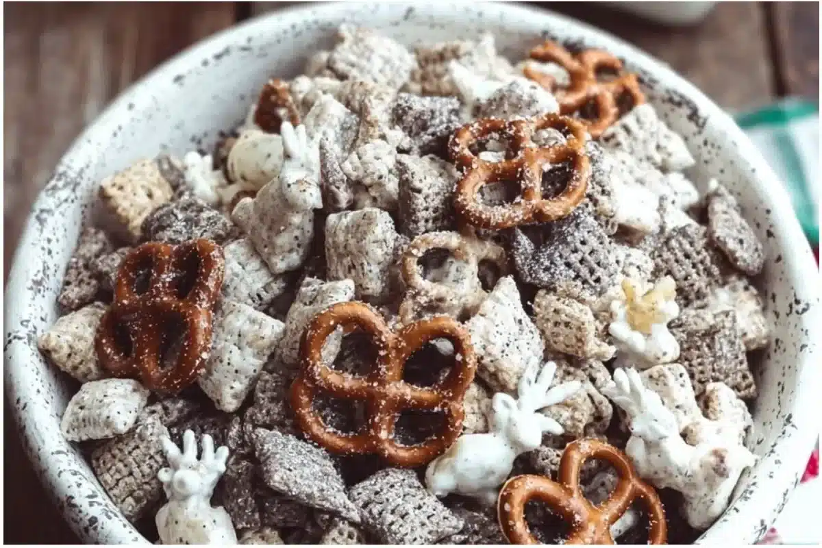 Bowl of gluten free reindeer chow snack mix with festive decorations