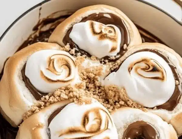 Delicious homemade gooey s'mores rolls topped with melted chocolate and marshmallows