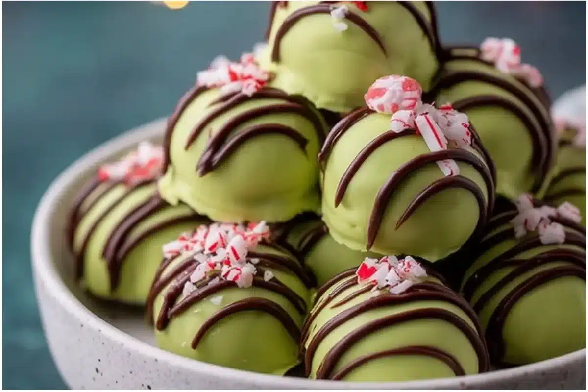 Festive Grinch Oreo Truffles decorated in green and red for Christmas