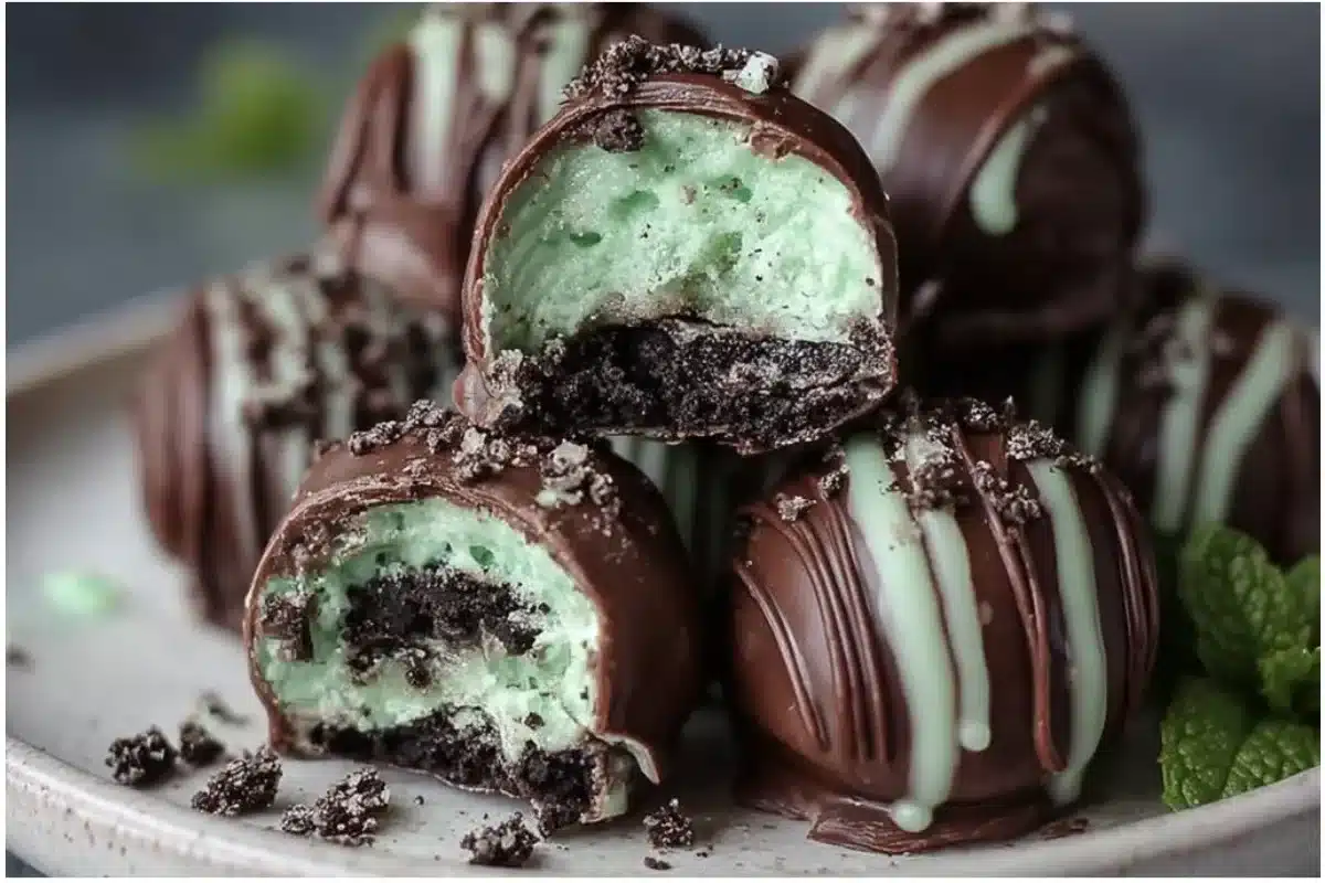 Mint Oreo Truffles drizzled with chocolate on a white plate