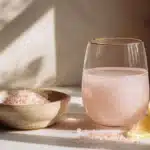 salt trick for women with pink himalayan salt lemon water in glass on marble counter