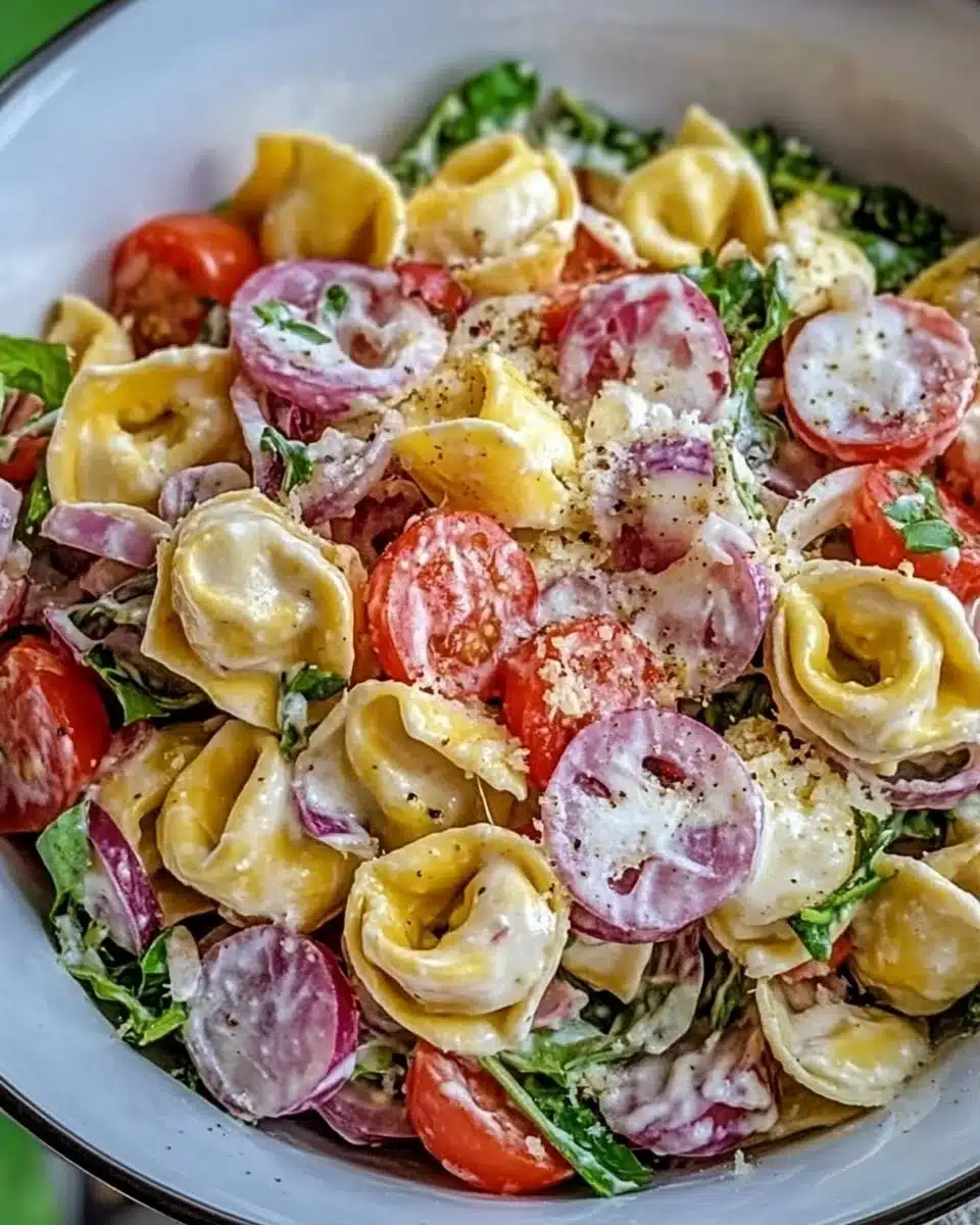 Vibrant bowl of Grinder Tortellini Salad with fresh ingredients and colorful vegetables