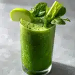 green detox smoothie for weight loss in glass with fresh spinach and celery