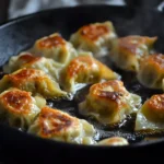 Cabbage Dumpling Recipe — The Healthy, Low-Carb Trick You'll Make Every Week 3 Pan-fried cabbage dumplings with golden crispy bottom edges sizzling in a black frying pan