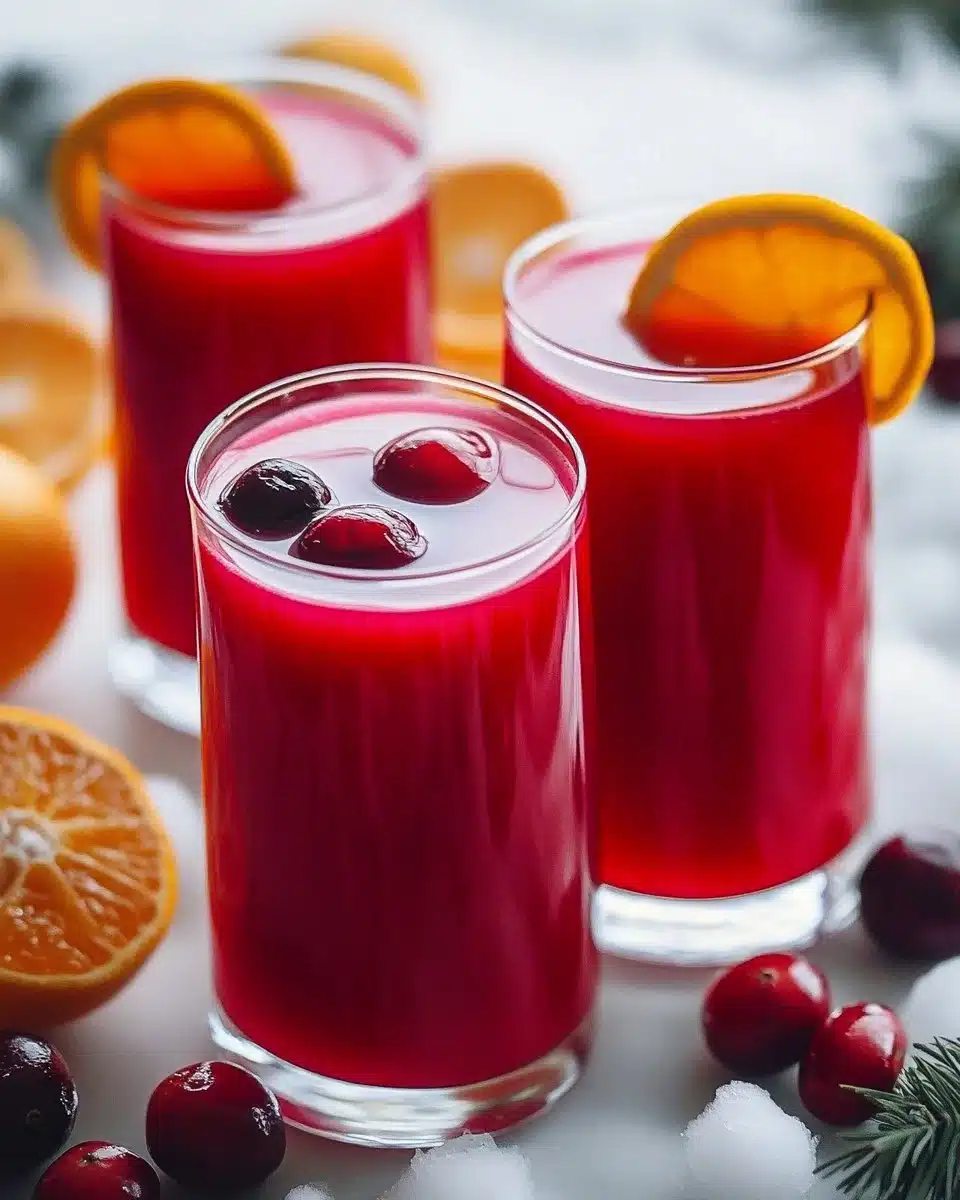 A refreshing glass of Cranberry Citrus Detox Juice with fresh ingredients