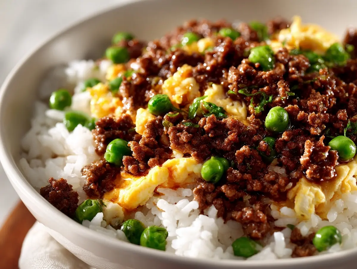 boy kibble recipe ground beef rice bowl with egg and vegetables on white ceramic plate