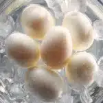 Brilliant Instant Pot Hard Boiled Eggs That Peel Perfectly Every Time 3 instant pot hard boiled eggs in ice bath bowl cold water close-up