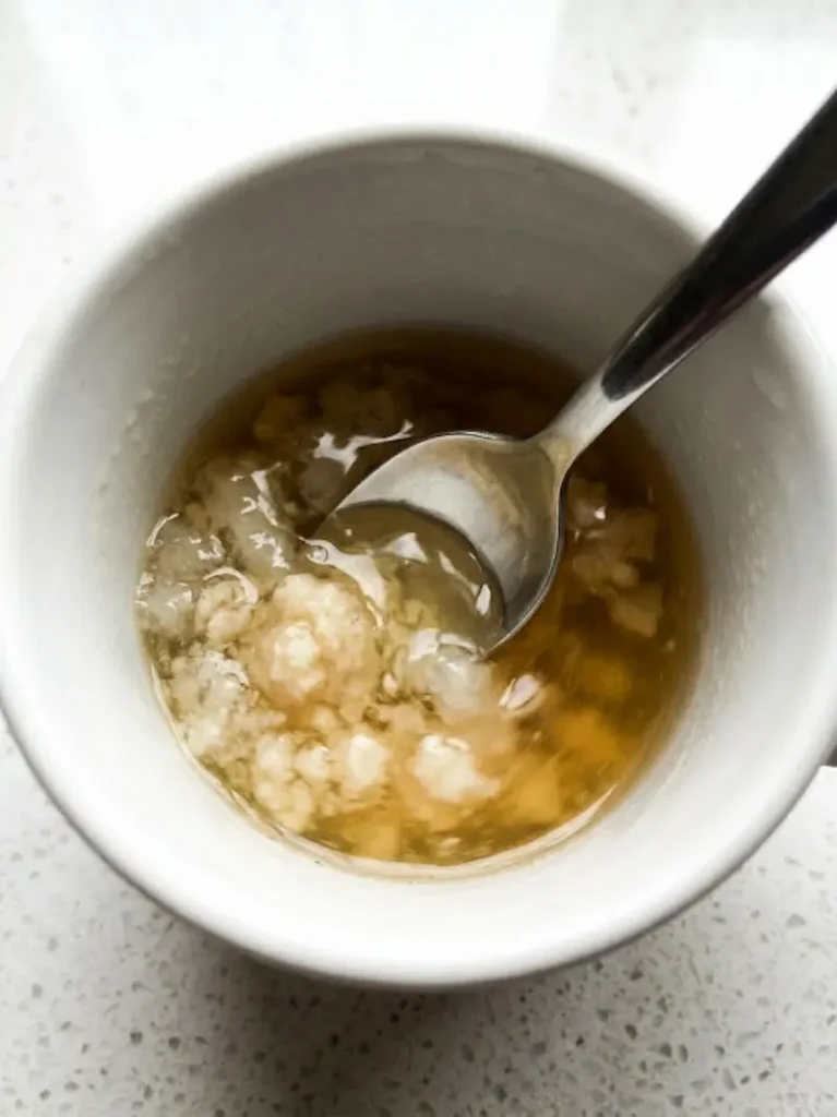 stirring dissolved gelatin in white mug for serena williams trick recipe
